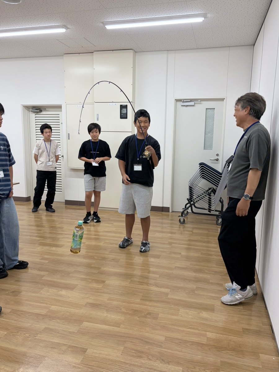 竿を持つ部員と、見守る講師